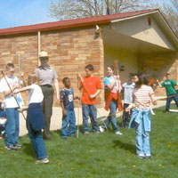 Students learn how to throw spears.