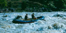 Raft going through rapids.