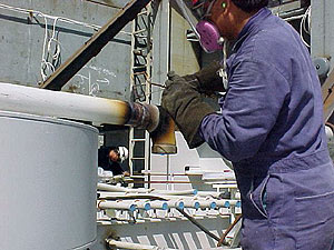Fig 1. Worker brazing on a pipe