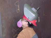 Fig 2. Welder with air-purifying respirator