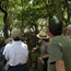 Ranger talks to group on wooded trail.