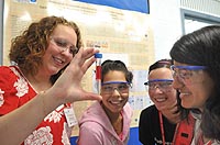 Teacher Heather Scott and students Stephanie Lamas, Dana Bielinski and Smriti Marwaha examine a test tube at Science Careers in Search of Women, hosted by the U.S. Department of Energy's Argonne National Laboratory