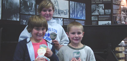Three new Junior Rangers show off their patches to Flat Stanley.