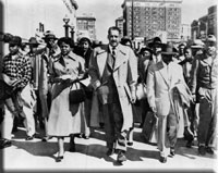 Autherine Lucy, with NAACP attorneys Thurgood Marshall and Arthur Shores, 
                    1956