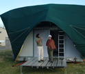 Photo of Drs. Jatinder Singh and Taranjit Kaur standing in front of their field laboratory.