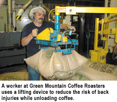 A worker at Green Mountain Coffee Roasters uses a lifting device to reduce the risk of back injuries while unloading coffee.
