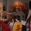 A ranger explains a museum exhibit to a group of students.