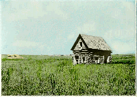 log cabin surrounded by prairie