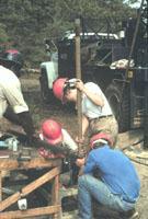 Field crew working to cap the bottom of the core liner after a successful coring attempt with the sample-freezing drive shoe