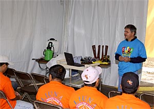 Workers from Laborer’s International Union of North America Local 800 listen intently to Cesar Asuaje from the University of Florida, during the "Pesticide and Personal Protection Equipment" training seminar
