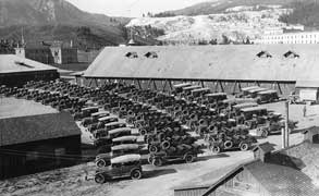 (YELL 33925) The Yellowstone Park Transportation Company fleet at Mammoth Hot Springs headquarters in 1920. White Motor Company seven-passenger touring cars are at the left foreground, most of the other vehicles are the eleven-passenger models. This facility and many of the vehicles were destroyed in a disastrous fire in 1925.