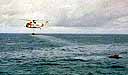  helicopter applies 800 liters (5 barrels or 211 gallons) of a dispersant, COREXIT 9500, to the oil