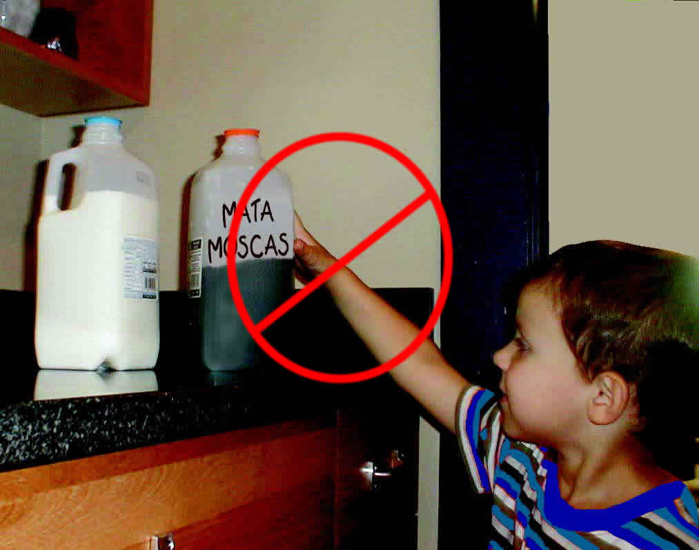 Child reaching for pesticide product on a kitchen counter that appears to be in a milk container.