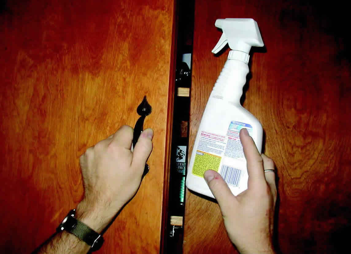 Storing a household cleaning product in an upper cabinet away from the reach of children.