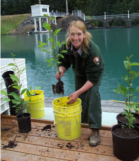 woman wearing NPS uniform holding plant