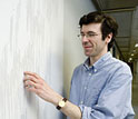 Jon Kleinberg of Cornell University in front of a tree diagram used in the research project.