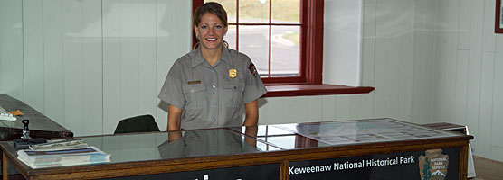 A park ranger waits at the information desk to help visitors.