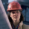 Woman on a construction site wearing a hardhat