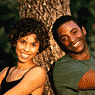 Young couple sitting under a tree