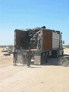 Image of tires being loaded on a truck