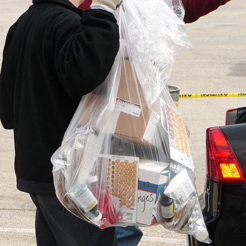 taking a bag of medications out of the trunk of  a car