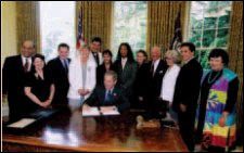 Photo of signing ceremony in the White House with President Bush