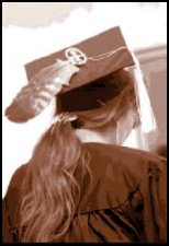 Photo of the back of a graduate with a feather in the hat.