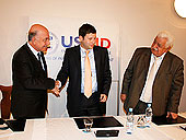From left: Mehmet Henefi Toremis (Turkish Electricity Transmission Corporation), Sulkhan Zumburidze (Georgia State Electrosystem), and Marlen Askerov (AzerEnergy) shake hands after signing an MOU to create the Power Bridge Project. 