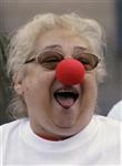 A woman attends a laughter therapy against the economic crisis in central Madrid October 1, 2008. REUTERS/Andrea Comas