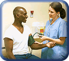 Female nurse taking male patient's blood pressure