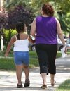 An overweight child walks alongside her mother. Over-eating, not a lack of exercise, is to blame for the American obesity epidemic, a new study claimed Friday, warning that physical activity could not fully compensate for excess calories.(AFP/Getty Images/File/Tim Boyle)