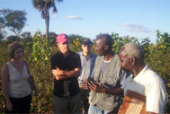Actor Matt Damon (in red cap), accompanied by his brother Kyle (centre) and Erin Thornton of DATA (extreme left) speak with Zambian organic cotton farmers Peter Mpilipili and Moses Mulenga. 042506. 