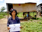 A client displays her designated plot number during land measurements on the river island of Koh Pich, near Phnom Penh