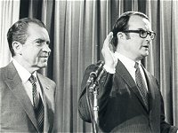 Photo of William Ruckelshaus's swear-in.  Left-to-right: President Nixon, William Ruckelshaus, Jill Ruckelshaus, and Warren Burger