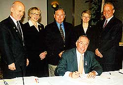 ACHP Chairman John L. Nau, III, signs the Interstate Highway exemption, as representatives from FHWA, the American Association of State Highway and Transportation Officials, and the ACHP staff look on. (staff photo)