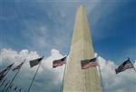 U.S. flags encircle the Washington Monument in the nation's capital, August 12, 2003. REUTERS/Larry Downing