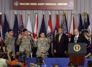 USCIS Director Emilio Gonzalez administered the Oath of Allegiance to Sergio Daniel Lopez (left), Noe De Jesus "Lito" Santos Dilone (middle), and Eduardo Leal Cardenas (right) at the Walter Reed Army Medical Center Naturalization Ceremony.