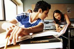 Students comparing notes in a classroom