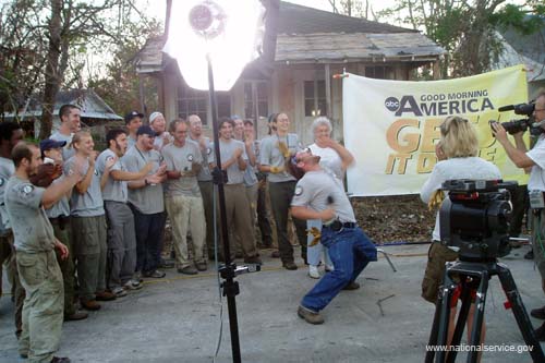AmeriCorps members applaud an exultant teammate, who just announced to the “Good Morning America” cameras that he and his colleagues had successfully cleared debris from a street in Pass Christian, Miss.
