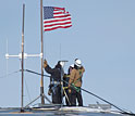 Photo of crew lowering the U.S. flag from the old South Pole Station Dome