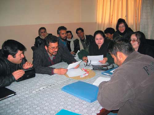 Photo: Budding playwrights review their scripts at the USAID Writing for Radio Workshop in Kabul.