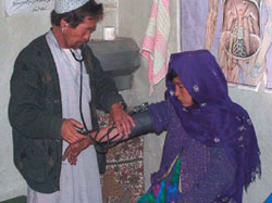 Photo: A young woman receives treatment at a USAID-funded Basic Health Center in Bamyan Province, Afghanistan.