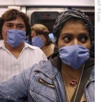 Train riders in Mexico City wear masks after outbreak of swine flu, 24 Apr 2009