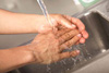 A person washing their hands.