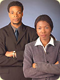 A business man and business woman; both have their arms folded.
