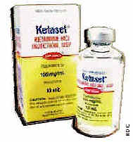 Photograph of a small bottle of Ketaset beside its packaging.