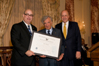 From left to right: USCIS Director Emilio T. González, Professor Elie Wiesel, and Deputy Secretary of State John Negroponte as Professor Wiesel is presented with the, "Outstanding American by Choice" recognition in Washington, DC Feb. 28, 2008
