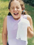 A girl is sneezing.