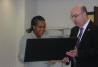 USCIS Director Emilio T. González presents Clementine M. Msengi with the “Outstanding American by Choice” recognition in Des Moines, IA, Apr. 19, 2006