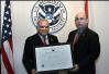 USCIS Director Emilio T. González presents Judge Jose E. Martinez with the “Outstanding American by Choice” recognition in Miami, FL, Jun. 16, 2006